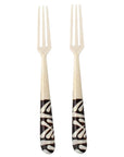 A pair of appetizer forks with batik patterned handles on a white background
