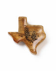 Wooden Texas-shaped cutting board with engraved design on a white background