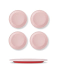 Set of four pink plates with a red rim on a white background