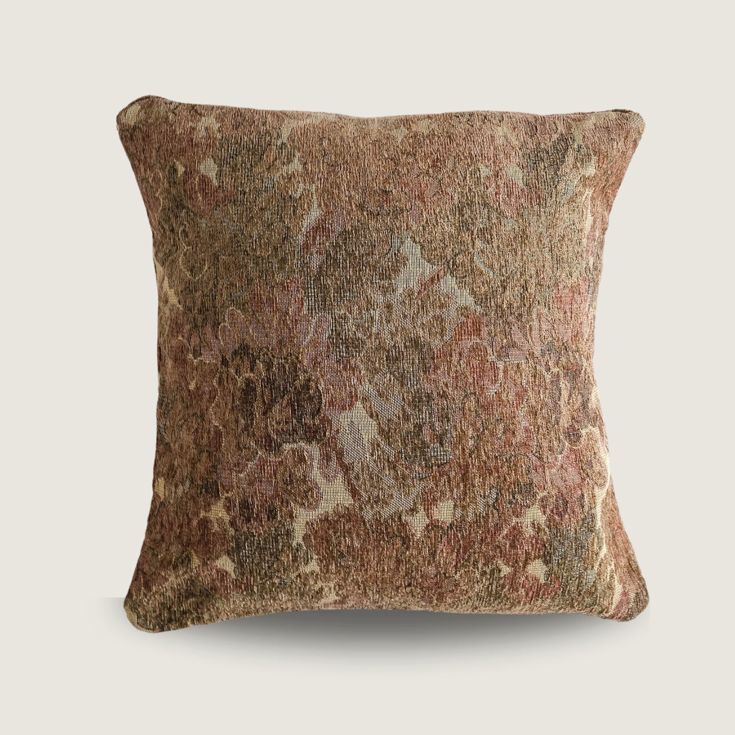 Textured pillow with a floral pattern on a light beige background