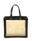 A black leather shoulder tote with rattan cane webbing and gold hardware.