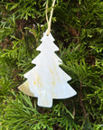 Beige Christmas tree ornament made of horn hanging on a christmas tree