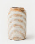 A cylindrical Etchra vase made of mango wood with horizontal carved lines, displaying a rustic grey color