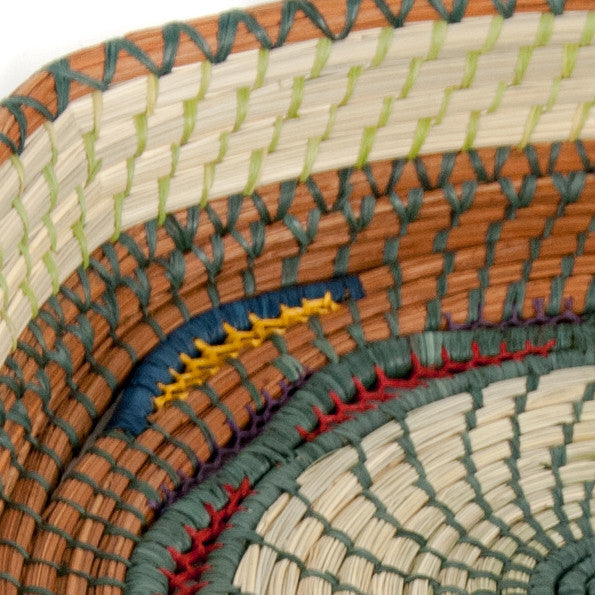 Close-up of woven mats with multicolored patterns
