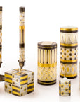 Decorative candles and containers with geometric patterns on a white background
