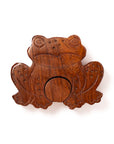 Wooden frog puzzle toy on a white background