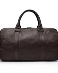 A brown leather weekender with a leather handle and visible stitching details.