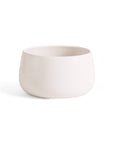 A hand-carved stoneware serving bowl with a white color and a capacity of 68 oz