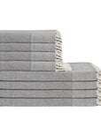 Stack of gray towels with white trim on a white background