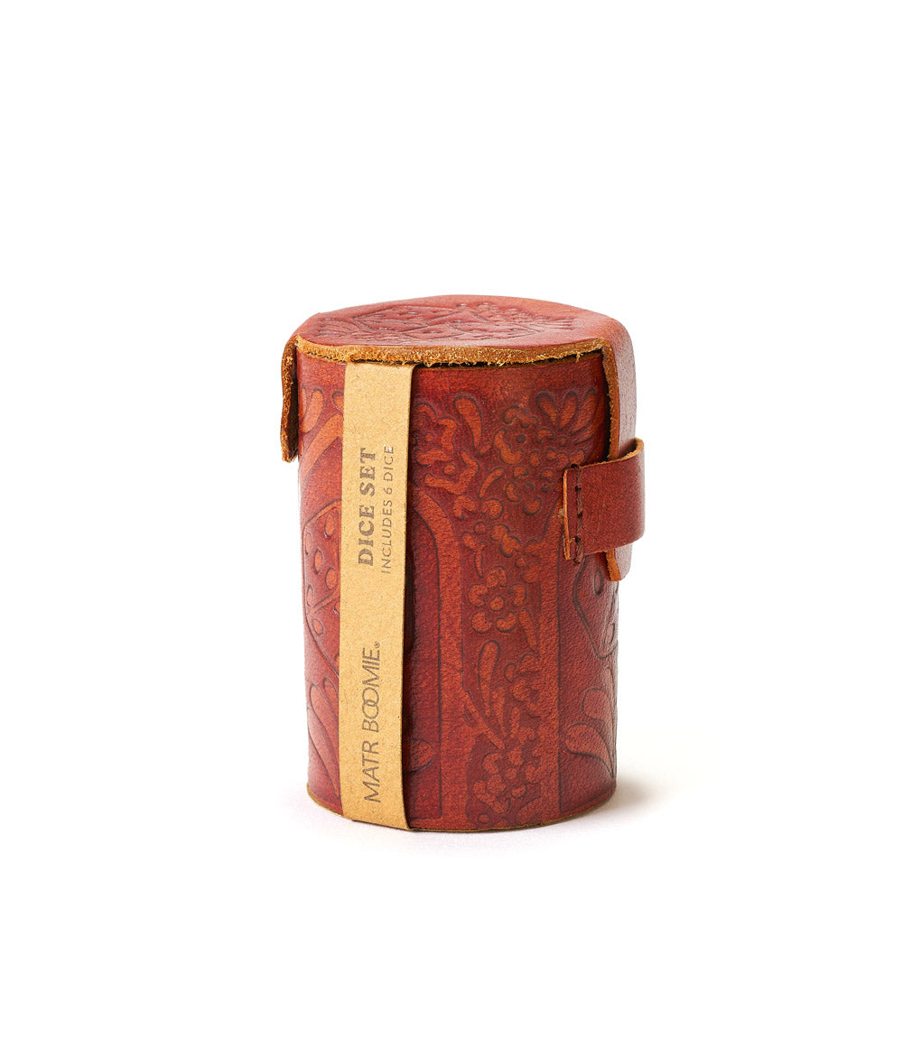 A closed hand tooled brown leather dice cup.