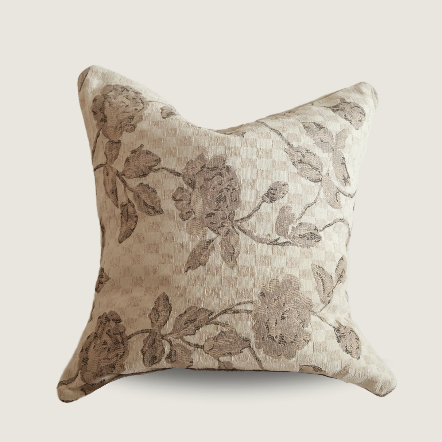 Decorative pillow with floral pattern on a beige background