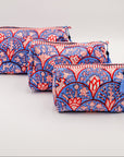 Three patterned pouches on a light gray background