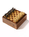 A portable wooden chess game with pieces carved from Indian rosewood, displayed on a white and brown checkered board.