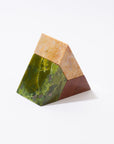 A triangular sculptural puzzle made of three pieces of different colored gemstones, arranged in a triangular formation on a white background.