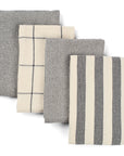 Set of four gray and white patterned towels on a white background