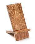 Wooden phone stand with tree of life design on a white background
