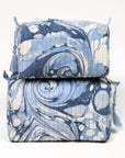 Two blue and white patterned bags stacked on a white background