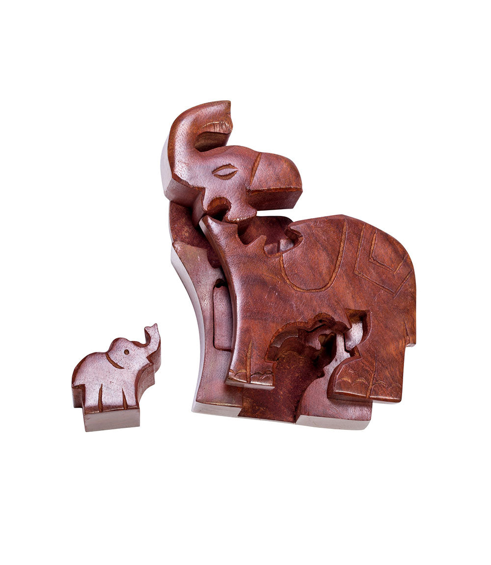 The pieces of Aahand-carved wooden puzzle box in the shape of an elephant with a baby elephant inside.