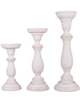 A set of three white shabby chic wooden candleholders in varying sizes
