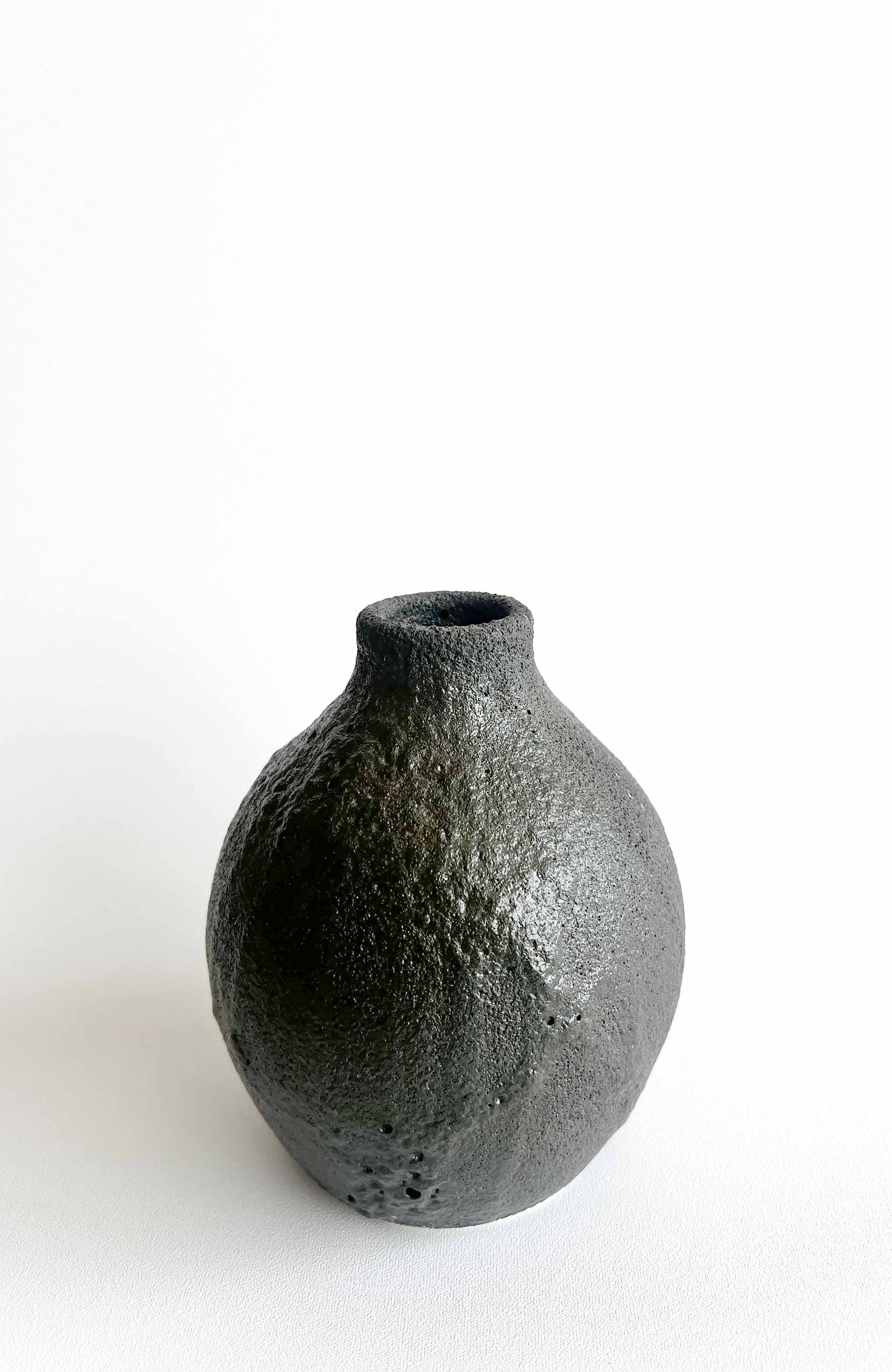 Black textured vase on a white background