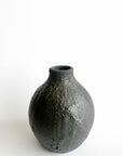 Black textured vase on a white background