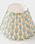 Lampshade with yellow and green leaf pattern on a white background