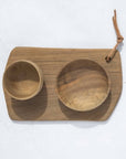 A rectangular walnut wood cutting board with two bowls, placed on a matching walnut wood tray