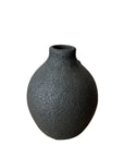 Textured black vase on a white background