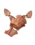 The puzzle pieces of a hand-carved wooden fox face puzzle box.