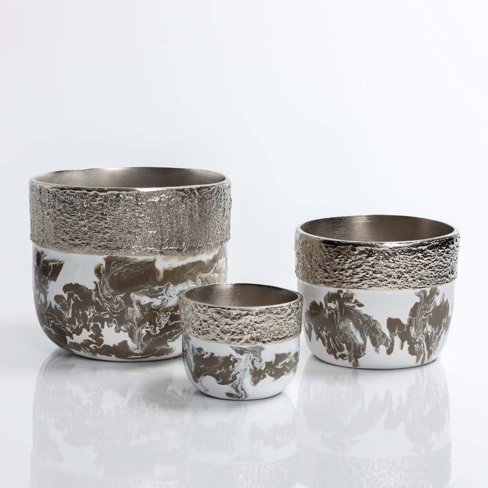 Set of three silver and white ceramic pots on a light gray background