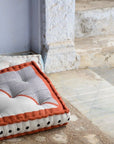 Textured indoor cushion with striped design on stone steps