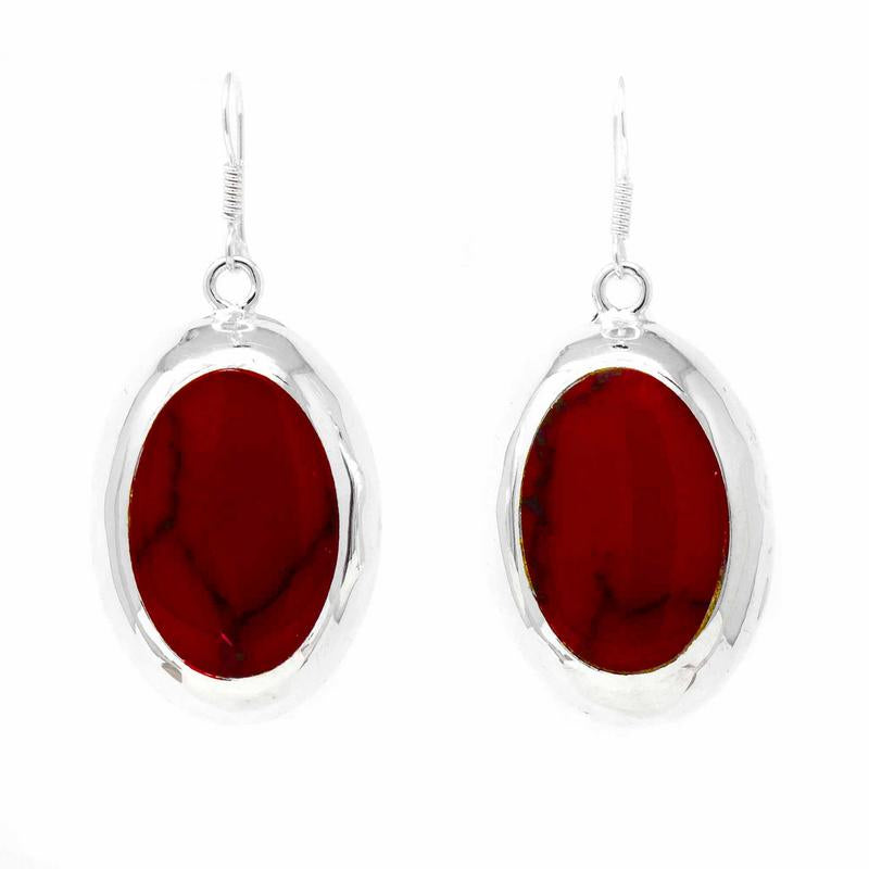 A pair of oval drop earrings with red centers and silver hypoallergenic posts.