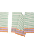 A set of four striped cotton napkins with a green and white pattern and a purple border