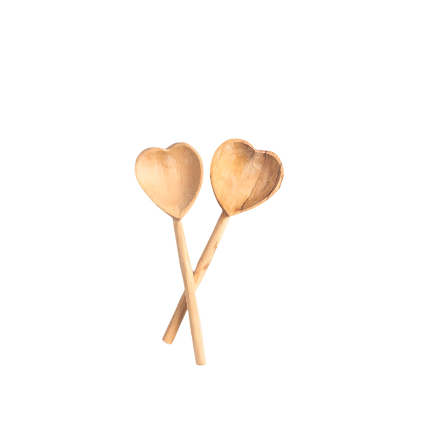A set of teaspoons shaped like a heart displayed on a white background