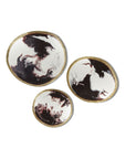Three circular coasters with artistic designs on a white background