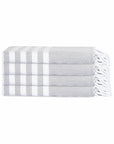 Stack of white towels with gray stripes on a white background