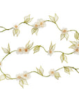 A floral garland made of natural abaca fibers with dyed green leaves and white flowers, designed for holiday decorations