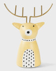 Decorative yellow reindeer figurine with gold antlers on a light gray background