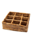 A square-shaped, sectional serving tray made from banana leaves with nine compartments