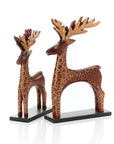 Decorative deer statues with intricate patterns on a white background