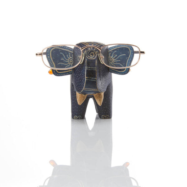 A wooden elephant figurine with hand-batiked designs, crafted to hold eyeglasses