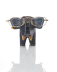 A wooden elephant figurine with hand-batiked designs, crafted to hold eyeglasses