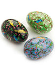 Three painted easter eggs with bird designs on a white background