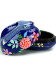 A decorative blue papier-mâché bunny box with hand-painted floral patterns, open lid showing the interior.