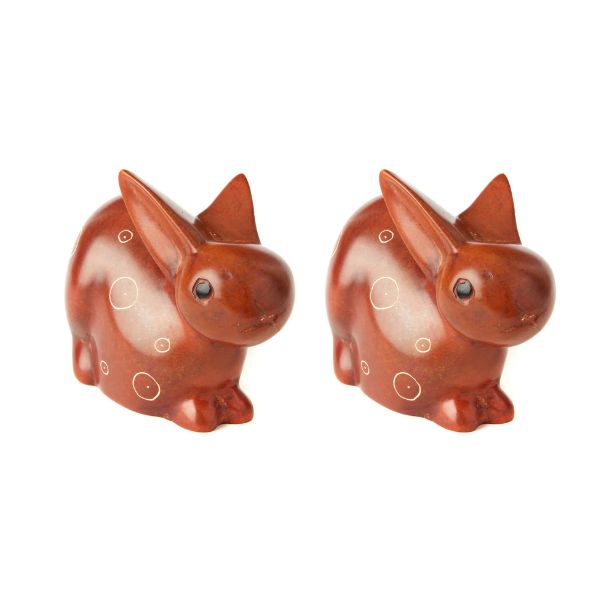 A pair of brown soapstone carved bunny figurines with etched details