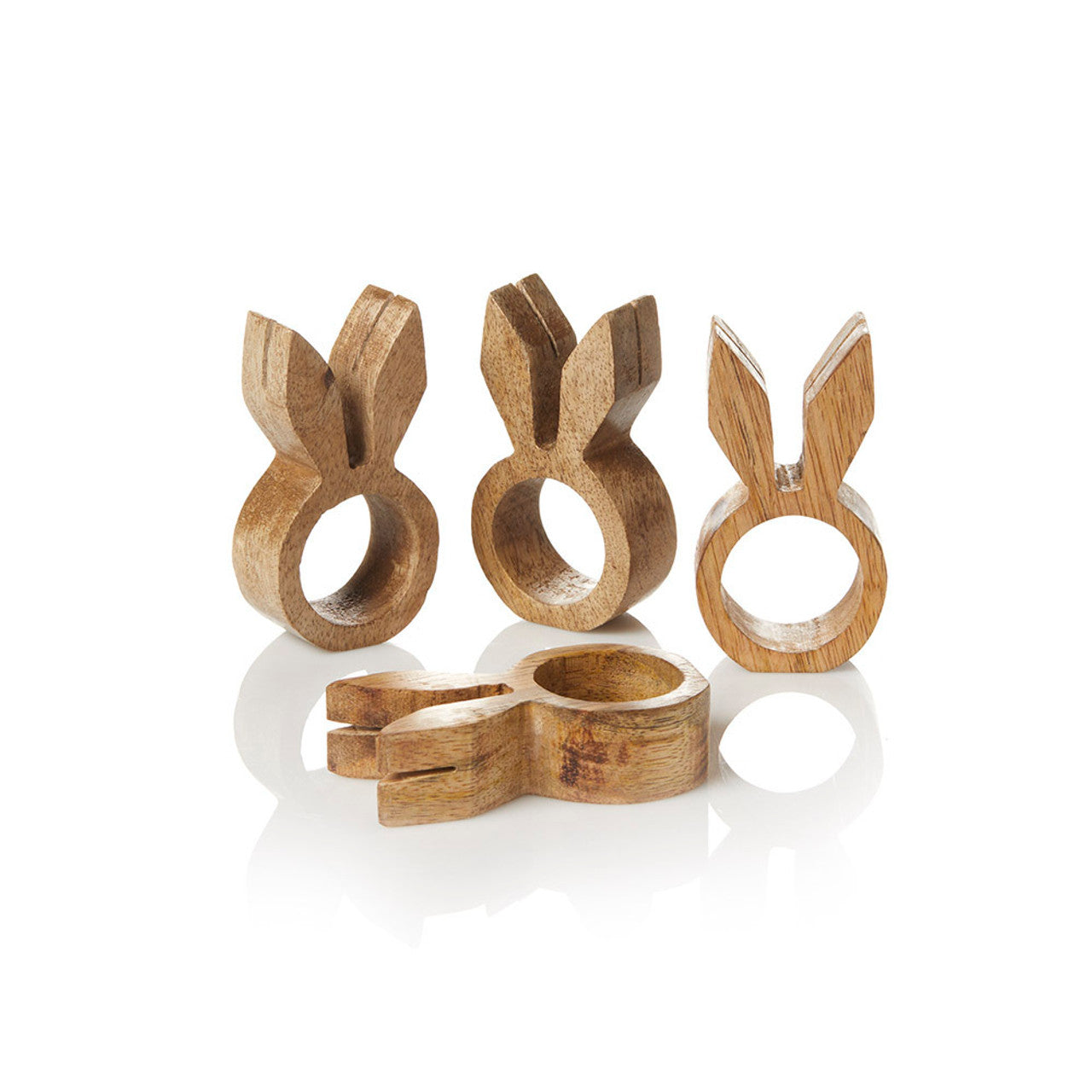 A set of four wooden napkin holders in the shape of rabbits with holes for napkin rings, displayed against a white background