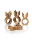 A set of four wooden napkin holders in the shape of rabbits with holes for napkin rings, displayed against a white background
