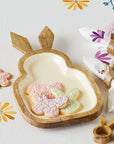 A rabbit-shaped serving tray made of wood holding three cookies