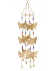Decorative hanging chime with gold butterfly shapes and colorful beads on a white background