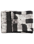 Black wax block printed handwoven linen scarf folded on white background